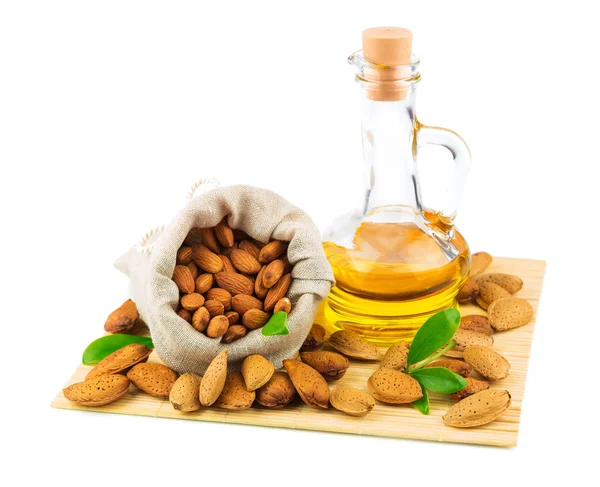 Almonds in the sack and almond oil — Stock Photo, Image