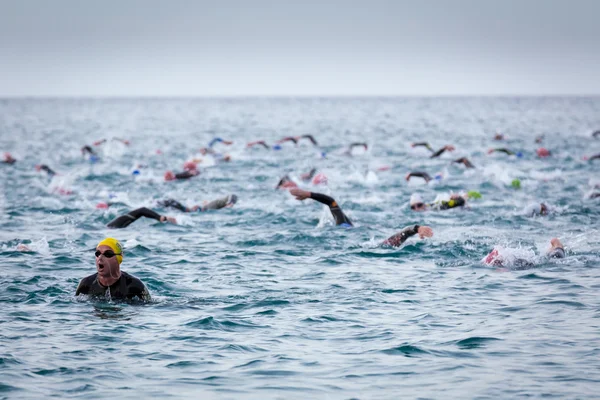 Calella, Spain, May 18. Triathletes swim on start of the Ironman triathlon competition at Calella beach, May 18, 2014 in Calella, Spain — Stock Photo, Image