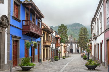 Street with colorful facades of houses in Teror clipart