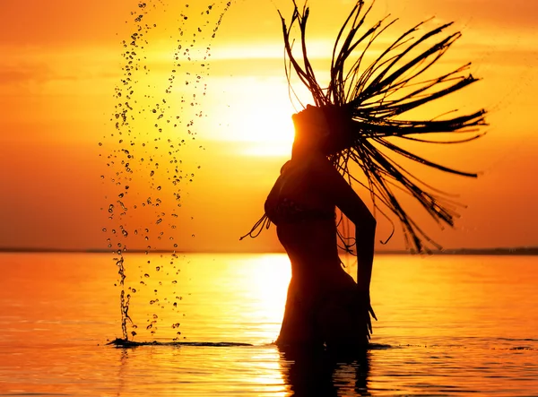 Female silhouette with splash of sea — Stock Photo, Image