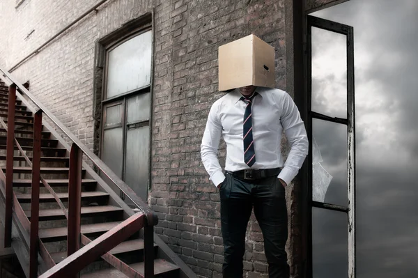 Man with carton box on head — Stock Photo, Image