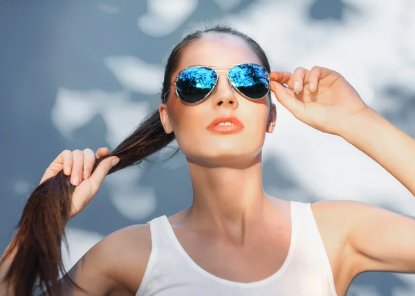 реклама очков. девушка в голубой оправе. девушка в голубых очках. портрет с солнечными очками в студии. блондинка в очках.