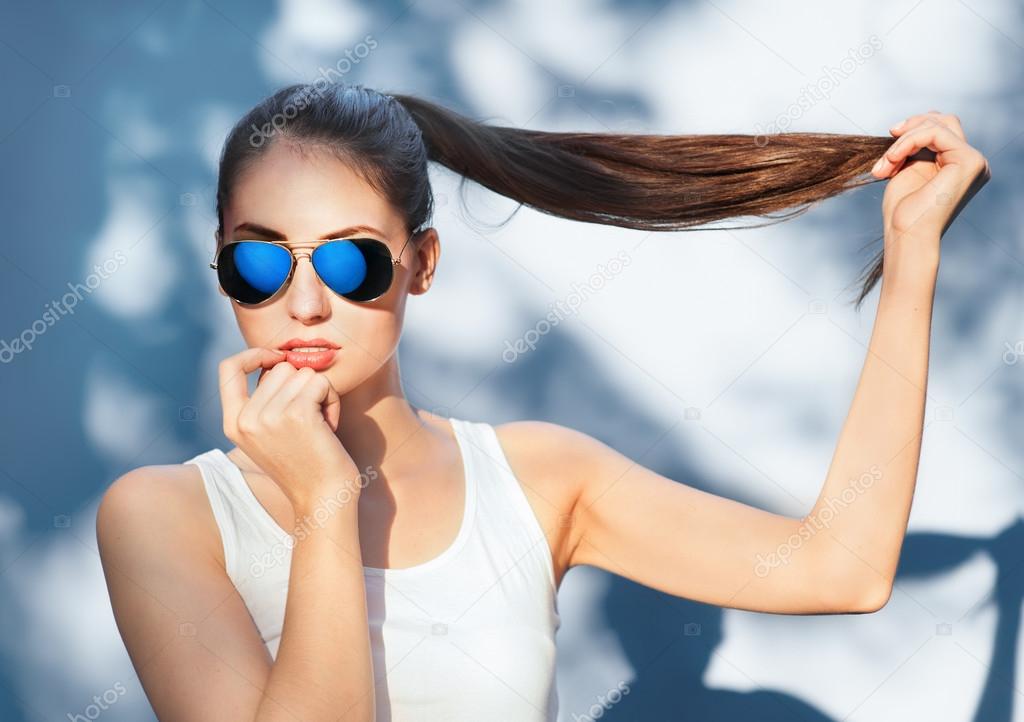 Attractive girl in mirrored blue sunglasses