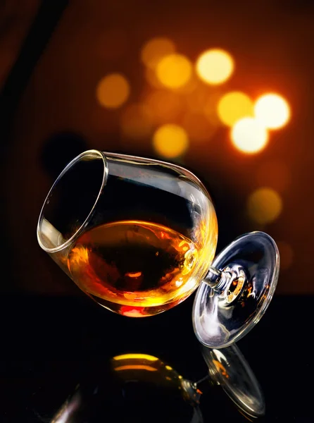 Cognac in tilted glass — Stock Photo, Image