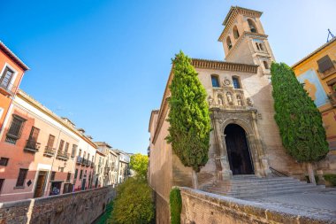 Cityscape of street and view on wall  with chapel and bell tower near Malaga cathedral. Malaga, Andalusia, Spai
