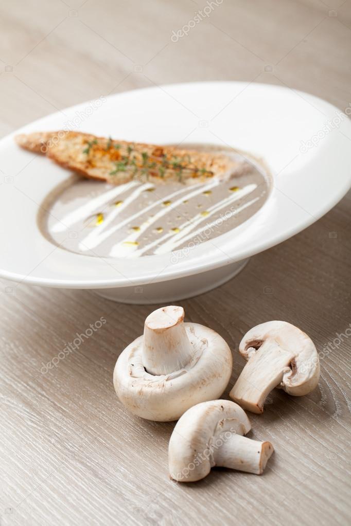 Vegetarian mushroom cream soup puree with baked bread cheese slice