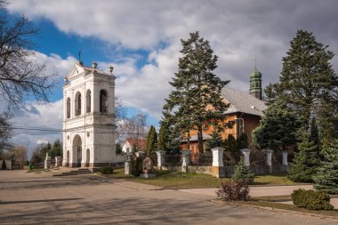 Wooden church and historic brick belfry in Warszawice, Masovia, Poland