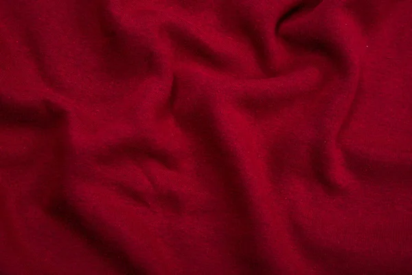 Pleats on fabric, knitted material of Crimson color, folds — Stock Photo, Image