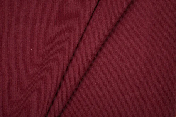 Pleats on fabric, knitted material of burgundy color, folds, knitted — Stock Photo, Image