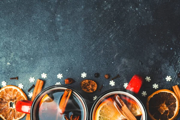 Mulled wine background. A hot winter Christmas drink based on red wine, spices and citrus fruits.