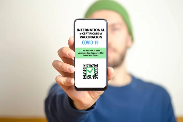 Coronavirus vaccination certificate or vaccine passport for travellers concept. COVID-19 immunity e-passport in the smartphone mobile app for international travelling.