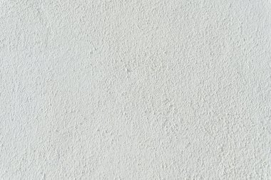 Boş bir duvarda açık gri alçı dokusu ve deseni.