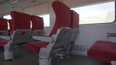 Interior of an empty carriage of a passenger train moving outside the city. Empty train with no passengers and travelers during the coronavirus pandemic