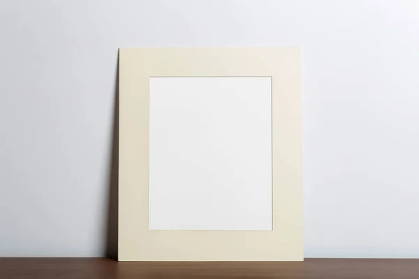 Mock up empty white frame background. Empty frame for a photo or painting in a light Scandinavian minimalist interior on a white clean wall.