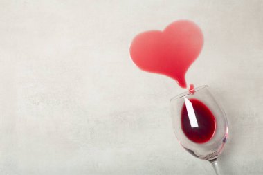 Altüst olmuş kırmızı şarap kadehiyle ahşap zemin. Ahşap kaplamalı parke döşemeye dökülen şarap, nem korumalı.. 