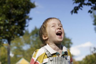 Portrait of a Cheerful Laughing Three-Year-Old Toddler Boy Outdoors. High quality photo