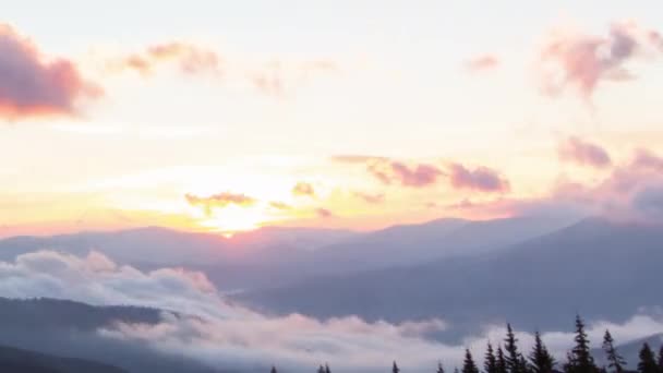 Nascer do sol romântico colorido nas montanhas. O sol nasce, nuvens azuis e alaranjadas fluem no céu. Majestosa paisagem maravilhosa. Cronometrias de câmera lenta Filmagem 4K. — Vídeo de Stock