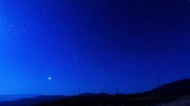 Koyu mavi gökyüzünde güzel yıldız izleri, açık hava ve yıldızlı gün. Yıldızlı gökyüzü, kuyrukluyıldızlar gibi yıldız izleriyle birlikte zaman kaybına uğrar. 8K.
