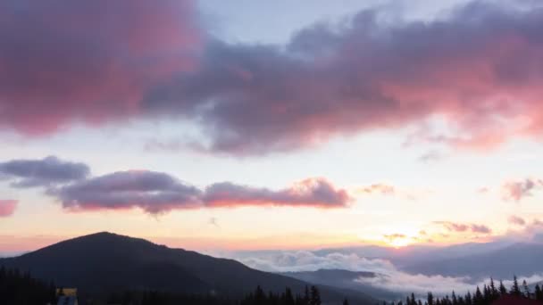 Romantic colorful sunrise at the mountains. Sun go up, blue and orange clouds flow in sky. Majestic wonderful landscape. Slow motion timelaps 4K footage. — Stock Video