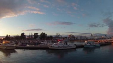 Sunset timelapse and boat silhouette at Olhão, capital of Ria Formosa wetlands natural conservation region landscape, Algarve, southern Portugal.
