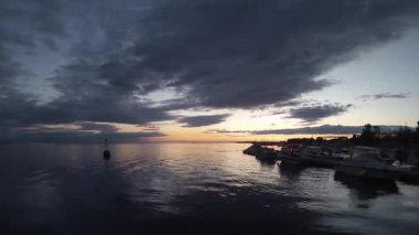 Sunset timelapse and boat silhouette at Olhão, capital of Ria Formosa wetlands natural conservation region landscape, Algarve, southern Portugal.