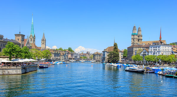 Zurich, Switzerland - 26 May, 2016: view along the Limmat river from the Quaibruecke bridge towards the Muensterbruecke bridge. Zurich is the largest city in Switzerland and the capital of the Swiss canton of Zurich.