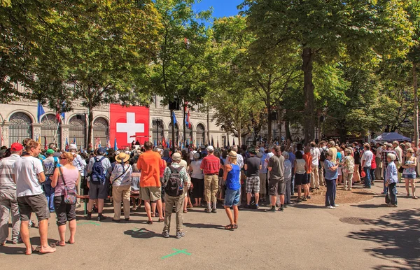 People listening to the speech devoted to the Swiss National Day