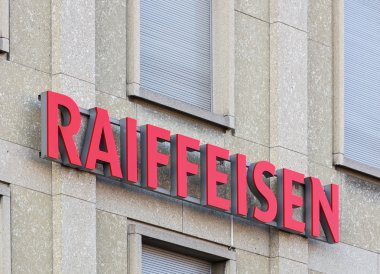 Raiffeisen sign on a building wall clipart