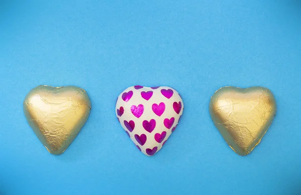 Hearts in gold packaging — Stock Photo, Image