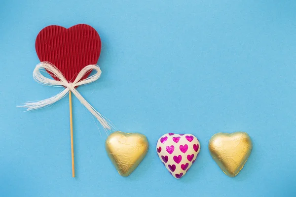 Hearts in gold packaging — Stock Photo, Image