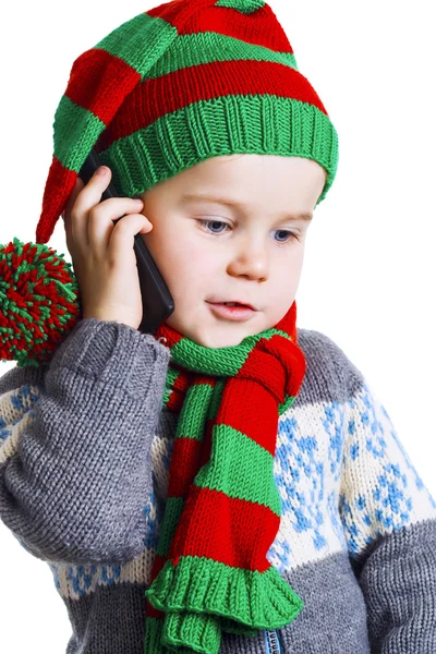 Christmas boy in knitted cloths makes a phone call to Santa Clau — Stock Photo, Image