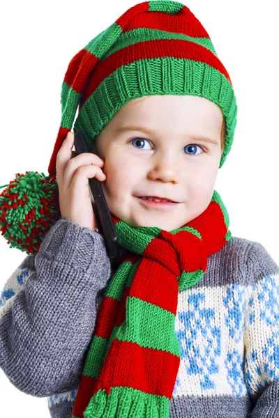 Christmas boy in knitted cloths makes a phone call to Santa Clau — Stock Photo, Image