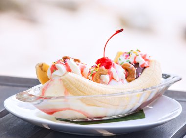 Banana split ice cream with whipped cream and cherry clipart
