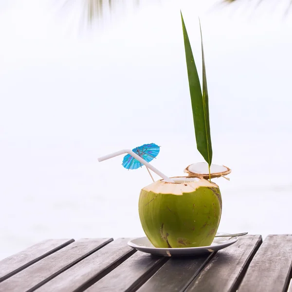 Kokosowe wody napoje serwowane w kokos ze słomką na — Zdjęcie stockowe