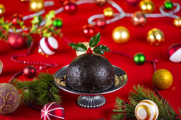 Christmas pudding on decorated table — Stock Photo, Image