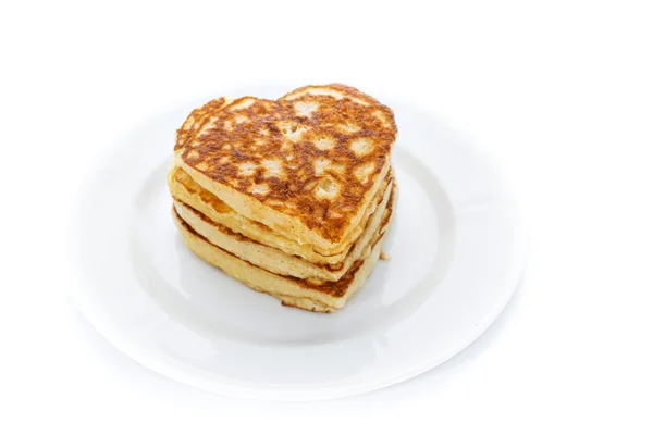 Pile of heart shaped pancakes on white plate — Stock Photo, Image