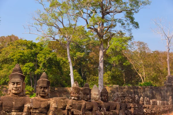 Standbeelden van oude khmer warrior hoofden voeren gigantische slang decorat — Stockfoto