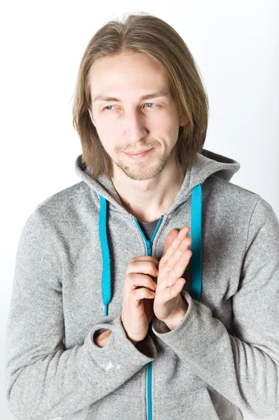 Portrait of young man with long blond hair on a white background — Stock Photo, Image