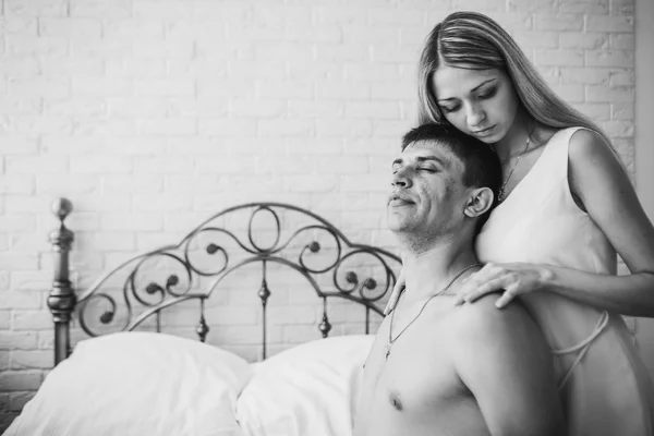 Young attractive happy amorous couple in bedroom — Stock Photo, Image