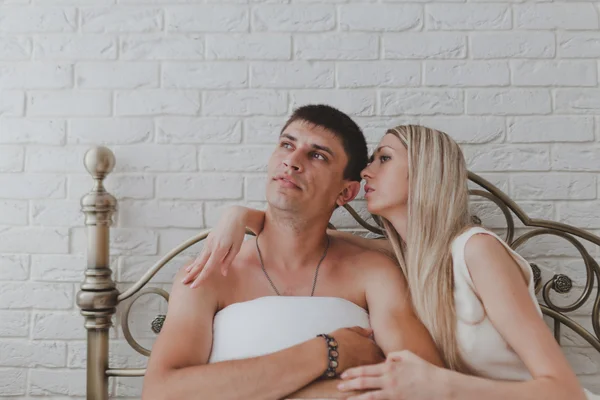 Young attractive happy amorous couple in bedroom — Stock Photo, Image