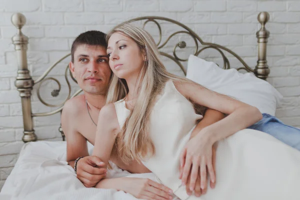 Young attractive happy amorous couple in bedroom — Stock Photo, Image