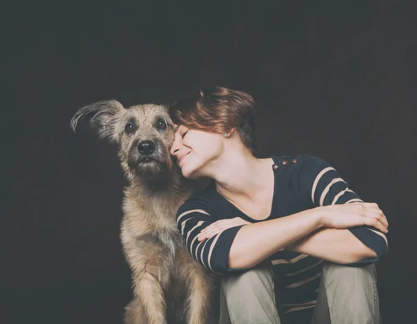 Retrato de uma bela jovem mulher com um cão desgrenhado engraçado em um — Fotografia de Stock