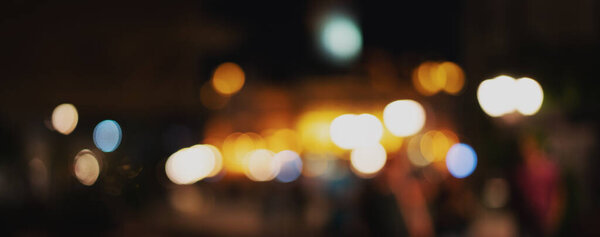 Blurred image. Defocused night city lights, panorama banner format
