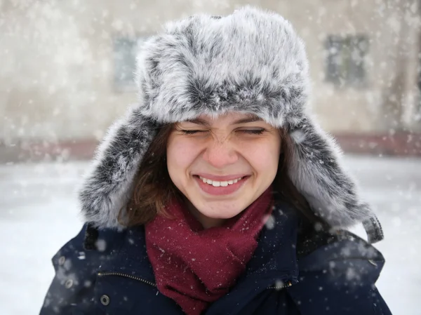 Cute funny girl in a fur cap laughing — Stock Photo, Image