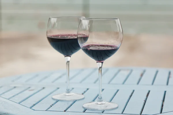 Two glasses with red wine on a table outdoor cafe