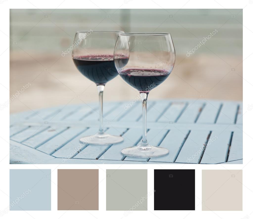 Two glasses with red wine on a table outdoor cafe, colour palett