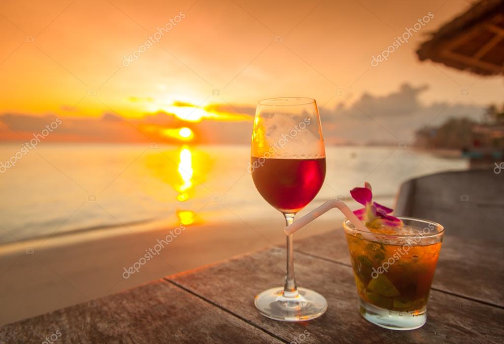 Two glasses of wine on table on sunset — Stock Photo