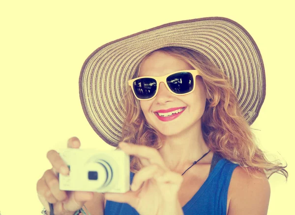 Porträt einer schönen jungen Frau mit Hut und Kamera in der Hand — Stockfoto