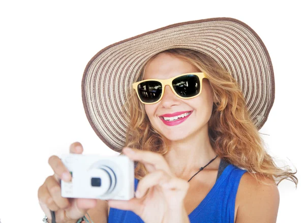 Portrait of a beautiful young woman in a hat with a camera in ha — Stock Photo, Image