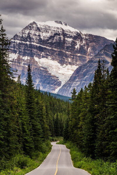 Mt Edith Cavell rises from the landscape at the end of a mountai
